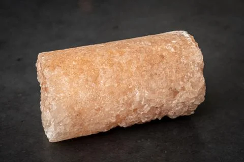 Salt crystal drill probe containing minerals causing its pink color Stock Photos