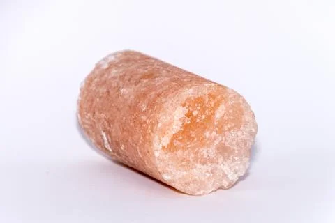 Salt crystal drill probe containing minerals causing its pink color isolated Stock Photos