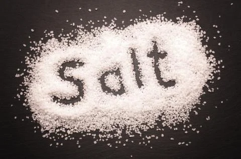Salt on dark slate Stock Photos