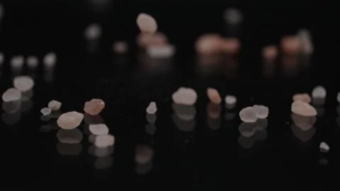 Salt dropping on a black surface table, macro blur effect Vidéo 205845191