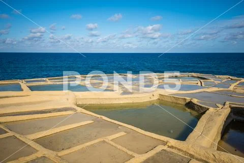 Salt evaporation ponds on Gozo island, Malta Stock Photos