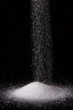 Salt Falling into a Pile Stock Photos