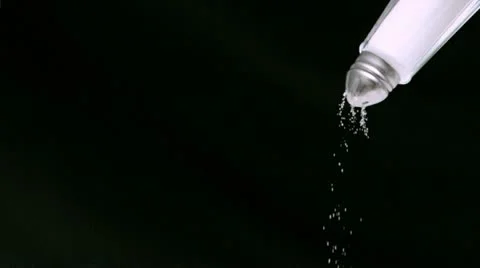 Salt falling in super slow motion from a salt shaker Stock Footage