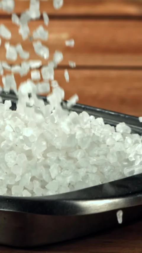 The salt falls into the container. Filmed on a high-speed camera at 1000 fps Stock Footage 335368366