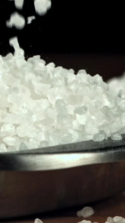 The salt falls into the container. Filmed on a high-speed camera at 1000 fps Stock Footage 335375776