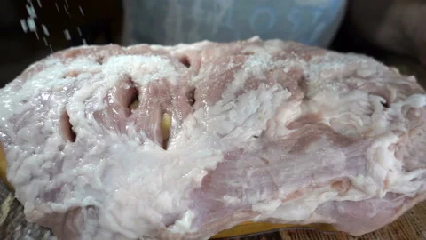 Salt falls on a raw meat in slow motion. Stock Footage 164284700