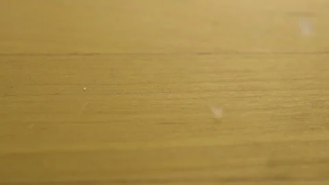 Salt falls on a wooden surface. Macro shot of salt crystals. Slow motion. Stock Footage 135250239