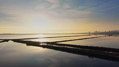 Salt fields and a sunset by the water in a coastal area Stock Footage 328525418