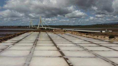 Salt fields on river Arade in Portimão with reflection of bridge Nova Stock Footage 140460076