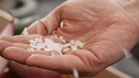 Salt flakes sprinkled on hand Stock Footage 103042613