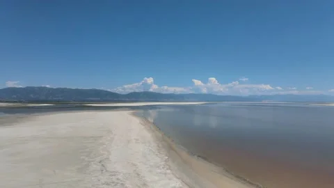 Salt Flat Beach Shoreline with Clouds over Mountains Video stock 154141653
