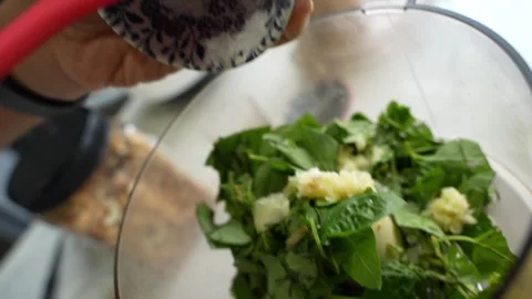 Salt getting used to garlic mint paste at blender in kitchen by chef. Stock Footage 291843912
