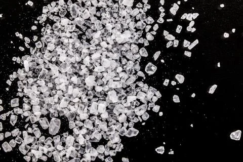 Salt grains on a black background macro Stock Photos