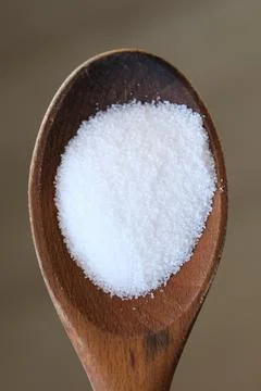 Salt grains on a spoon Stock Photos