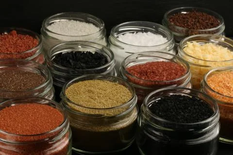 Salt in jars on black background. Close up Stock Photos