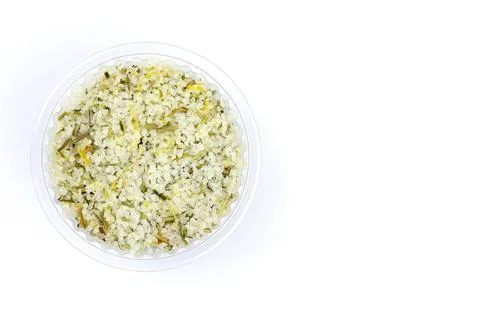 Salt with lemon in a plastic container on a white background Foto stock