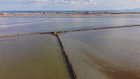 Salt mining area with water and land during daylight hours Stock Footage 335141075