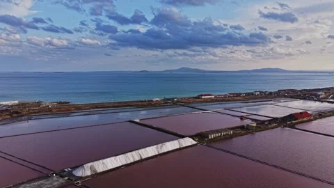 Salt mining process at coastal site with water and clouds Stock-Footage 335141399