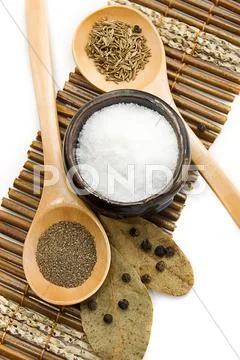 Salt, pepper, cumin and bay leaf Stock Photos