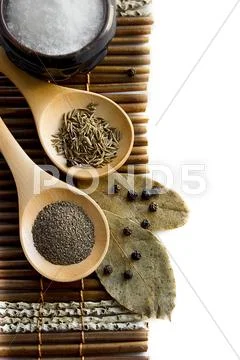 Salt, pepper, cumin and bay leaf Stock Photos