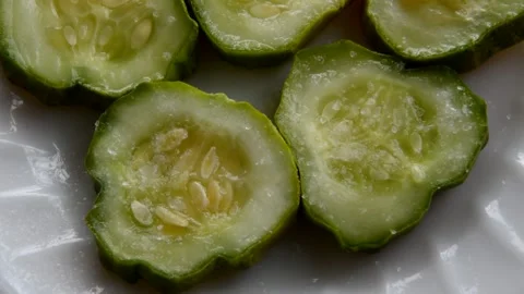 Salt is poured onto a cucumber Stock Footage 271445813