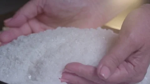 Salt poured from the hands, slow motion Stock Footage 75240323