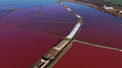 Salt production process takes place in fields with colored water Stock Footage 328527337