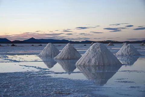 Salt pyramids reflection in a salt flat at sunset Stock-Fotos