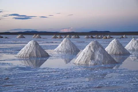 Salt pyramids in a reflective salt flat Stock Photos