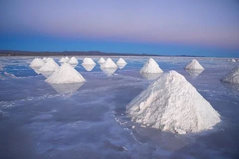 Salt pyramids in a reflective salt flat Stock Photos
