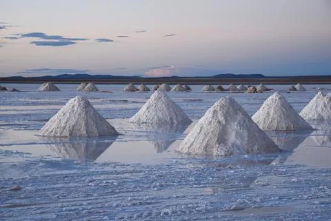 Salt pyramids in a reflective salt flat Stock Photos
