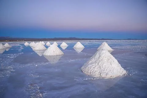 Salt pyramids in a reflective salt flat Stock Photos