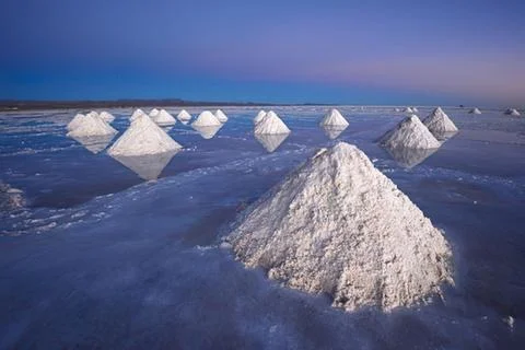 Salt pyramids in a reflective salt flat Stock Photos
