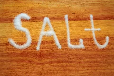Salt scattered on the Board in the for Stock Photos