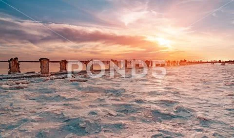 Salt sea water evaporation ponds with pink plankton colour Stock Photos