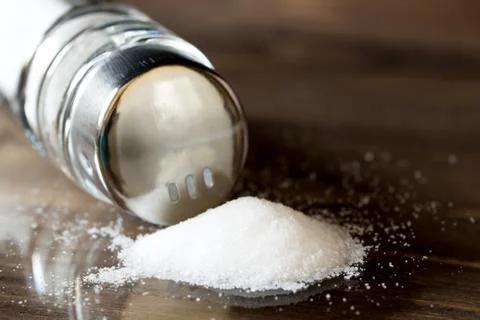 Salt spilleng on a table from shaker Stock Photos