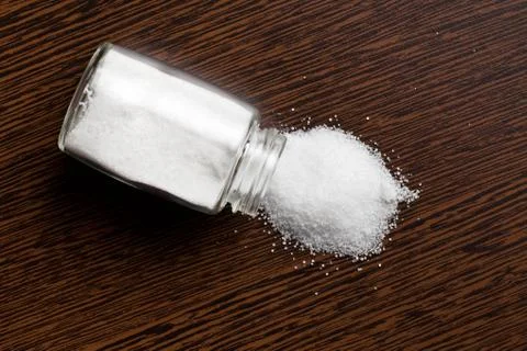 Salt sprinkled on table Stock Photos