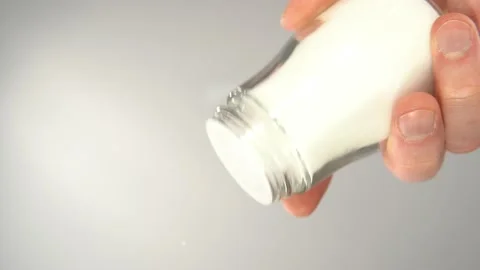 Salt is sprinkled on a transparent surface, bottom view. Stock Footage 170435012