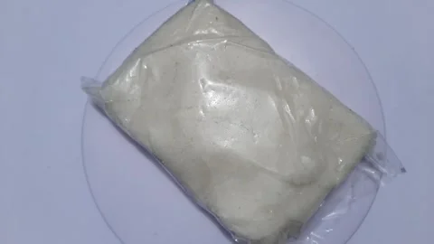 Salt in a transparent plastic container is placed on a rotating display Stock Footage 246631881