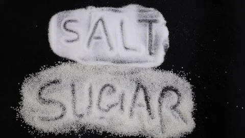 Salt versus sugar concept with crystal lettering and nutrition awareness them Stock Footage 336646011
