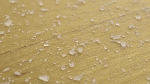 Salt on a wooden surface. Moving platform with salt crystals. Stock Footage 135240550