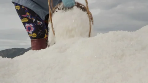 Salt Worker Deposits Salt on Large Hill Stock Footage 42432645