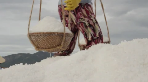 Salt Worker Deposits Salt on Large Hill Stock Footage 42433615