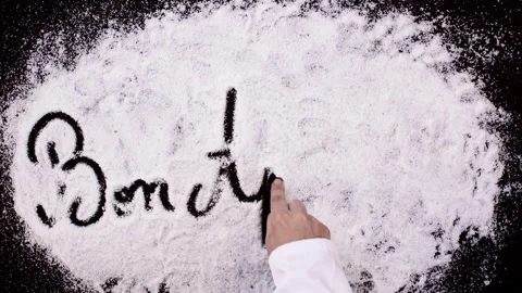 Salt Writing on Black Surface Bon Appetit Stock Footage 248749782