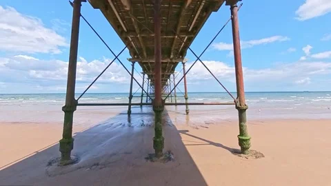 Saltburn beach captured from under the pier on a bright and sunny day Stock Footage 245807720