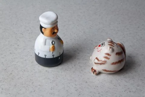 The saltcatcher and the cook-timer look at each other Stock Photos