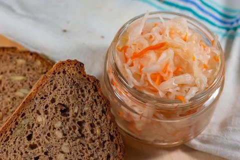 Salted cabbage and bread lies on a towel Stock Photos