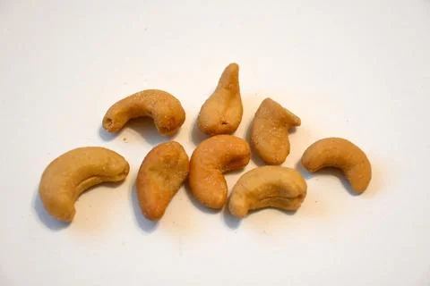 Salted cashew nuts on a white surface Stock Photos