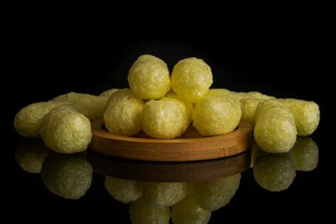 Salted corn puff isolated on black glass Stock Photos