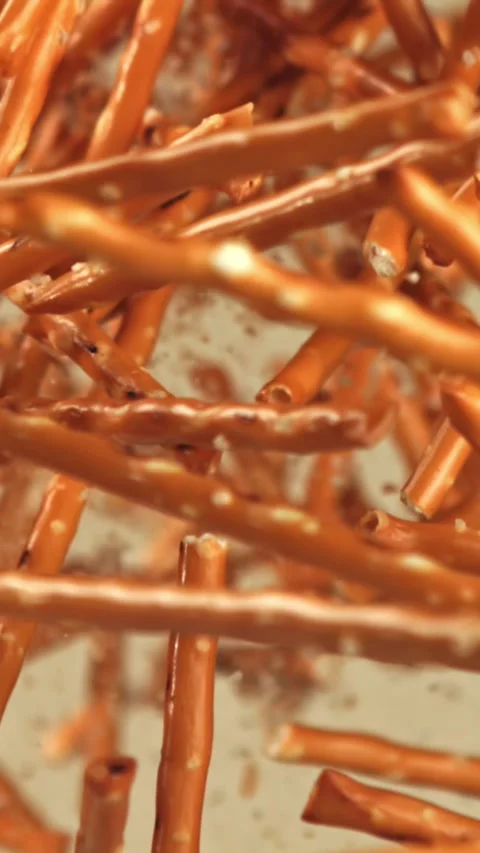 Salted cracker sticks fly and fall. Filmed on a high-speed camera at 1000 fps Stock Footage 335368432